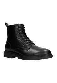 Stivaletti neri in pelle con punta tonda, chiusura con lacci e suola in gomma nera robusta. Presentano un pratico tassello sul retro.