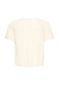 Blouse crème à manches courtes et coupe ample, avec un motif texturé vertical subtil et un col rond, vue de dos.