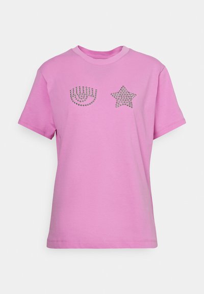Pink cotton t-shirt featuring metallic embellishments: an eye shape and a star. Short sleeves, crew neckline, and a relaxed fit.