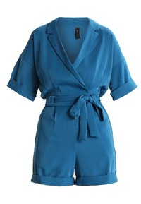 Teal kortärmad jumpsuit i mjuk tyg. Har en omsluten design, djup V-ringning och ett knytbälte i midjan. Rullade manschetter p å ärmarna.
