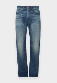 Σκούρα μπλε τζιν με ευθύ μπατζάκι, με ελαφριά ξεθώριασμα, πέντε τσέπες και κλείσιμο με κουμπί στη μέση.