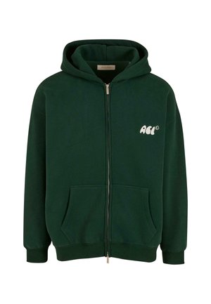 Green zip-up hoodie with a front pocket and drawstring hood. Features a small white logo on the left chest. Soft, textured fabric.