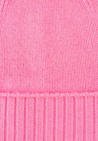 Pink knitted beanie with a smooth, elastic texture. It features a ribbed band at the base, enhancing fit and comfort.