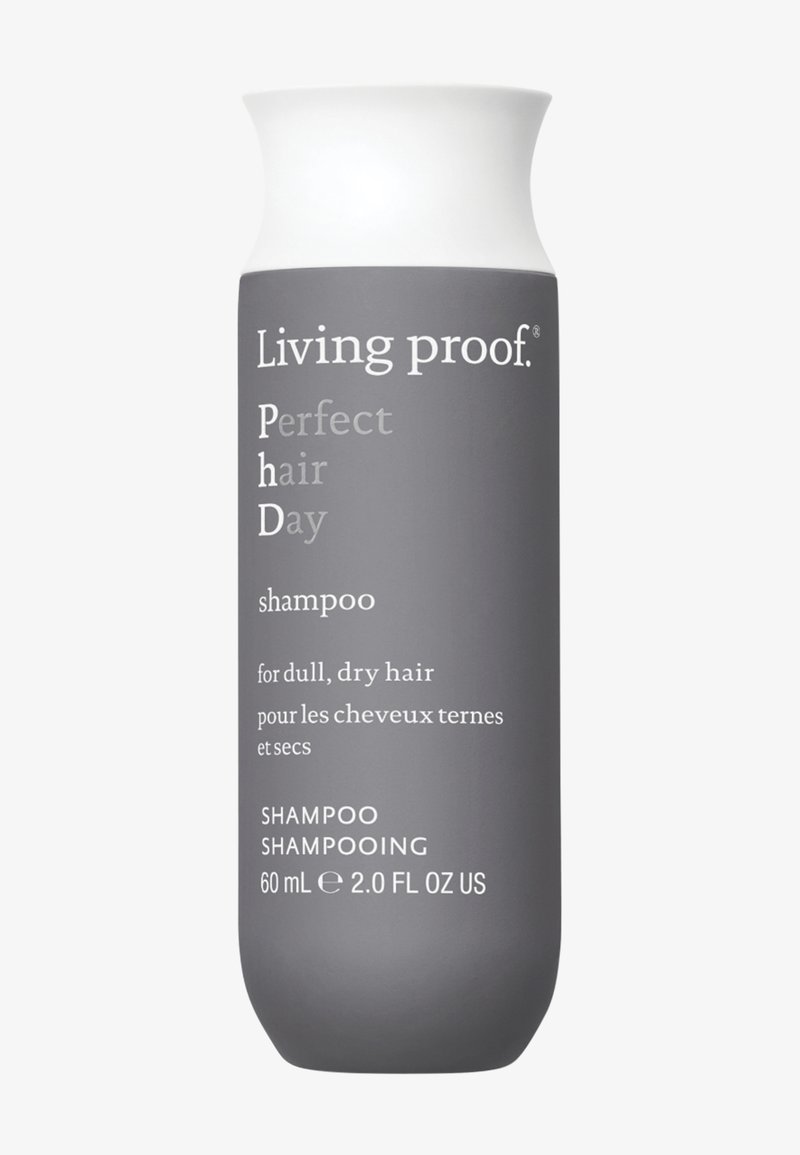 Flacon de shampooing Living Proof Perfect Hair Day pour cheveux ternes et secs, 60 ml, avec corps gris et bouchon blanc.