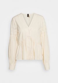 Blusa color crema con scollatura a V profonda, maniche lunghe a sbuffo, tessuto strutturato e dettagli arricciati in vita. Strisce verticali su tutta la superficie.