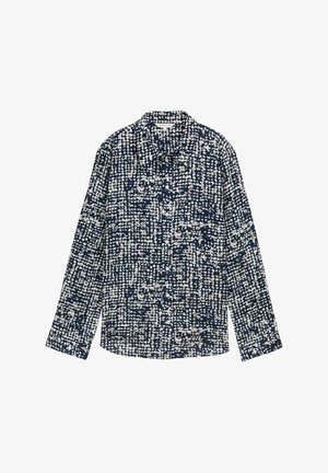 Tumedast sinine nööpidega särk valgete abstraktsete täppidega, pikkade varrukatega, kraega ja veidi kaarduva hemiga, valmistatud kergest materjalist.