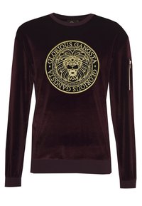 Felpa in velluto bordeaux con motivo di leone dorato in un design circolare, polsini e orlo a coste, e una tasca con zip sulla manica.
