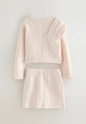 Light pink knit sweater and skirt set with a cable pattern and textured accents. Sweater features a round neckline and ribbed cuffs, skirt has a ribbed waistband.