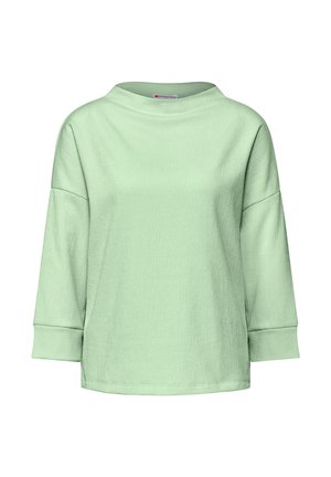 T-shirt à manches longues vert clair en tissu texturé, col large et épaules tombantes. Il présente une coupe ample et des manches légèrement évasées.