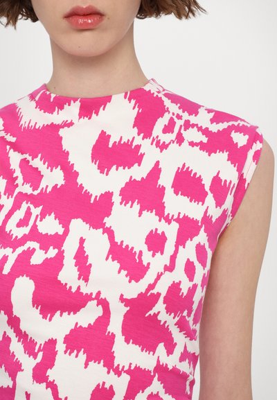 Fitted top featuring a pink and white abstract leopard print design, textured fabric, and cap sleeves.