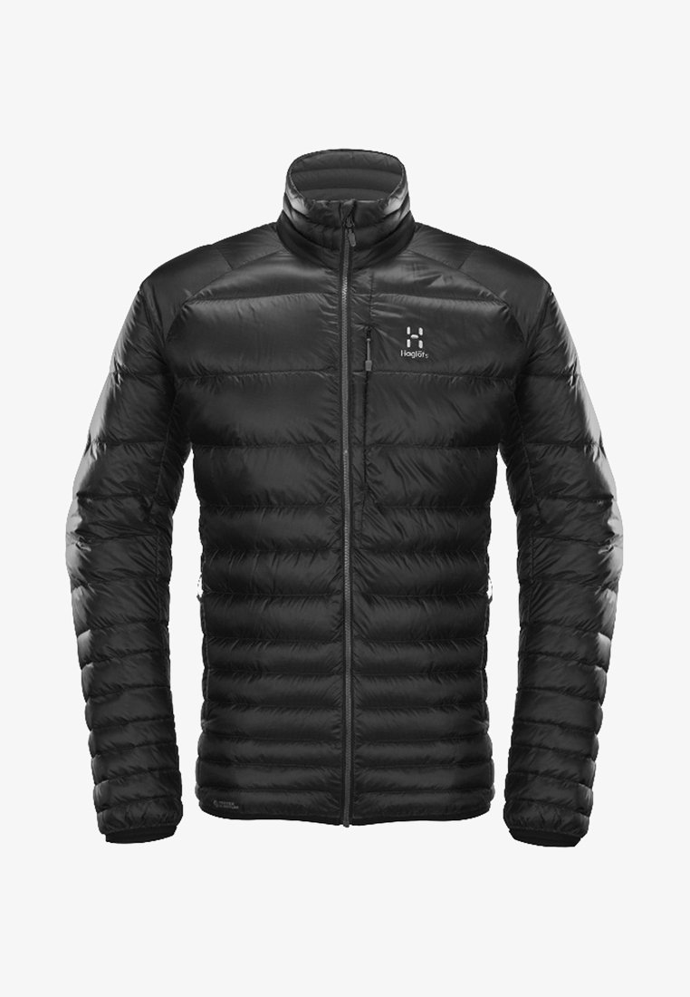 Veste matelassée noire avec fermeture éclair frontale, col montant, poche poitrine zippée et logo Haglöfs sur la poitrine gauche.