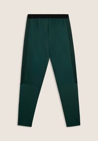Leggings de sport vert foncé avec une taille noire, en tissu lisse, dotés de panneaux latéraux en mesh et de détails d'accent au niveau des genoux, conçus pour le confort et la flexibilité.