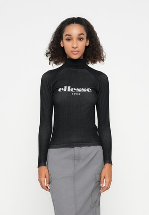 Haut à manches longues noir avec un col montant, présentant un logo blanc "ellesse 1959" à l'avant, fabriqué dans un matériau extensible au toucher lisse.