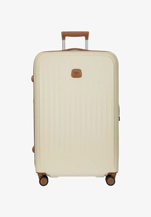 Valigia rigida color crema con rifiniture marroni, manico telescopico e quattro ruote girevoli.