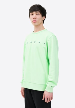 Light green long-sleeve sweatshirt made from cotton with a round neckline and "SPORT" printed in black across the chest. Smooth texture.