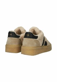 Tan suede and beige shearling sneakers with black accents, a textured outsole, and a slightly elevated platform. Features logo detail.