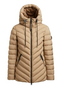 Doudoune beige avec un design matelassé en chevrons, col montant, deux poches latérales zippées et cordons de serrage noirs sur la capuche.