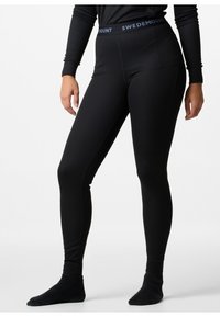 Black ribbed leggings with a fitted design, featuring a branded elastic waistband. Material appears soft, suitable for layering.