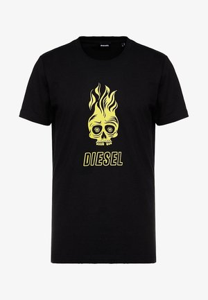 Czarny T-shirt z krótkim rękawem z żółtą płonącą czaszką oraz napisem „DIESEL” na środku z przodu.
