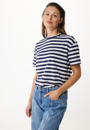 Striped t-shirt featuring navy and white horizontal stripes, short sleeves, and a round neckline, paired with high-waisted blue denim jeans.