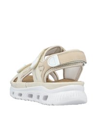 Beige athletic sandals with a suede upper, open design, adjustable straps, and a white cushioned sole featuring ventilation holes.