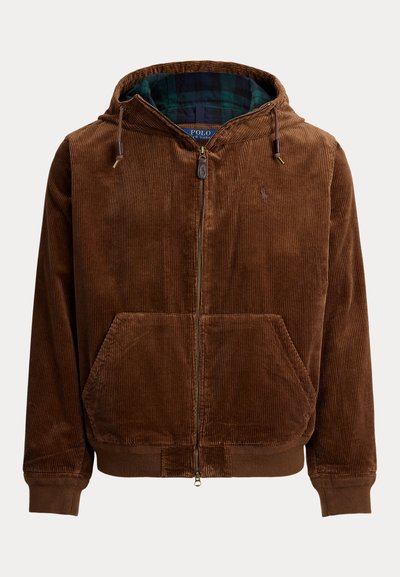 Hnedá korduroy mikina s predným zipsom, kapucňou na šnúrku a prednými vreckami. Obsahuje modro-zelenú kockovanú podšívku. Mäkká textura.