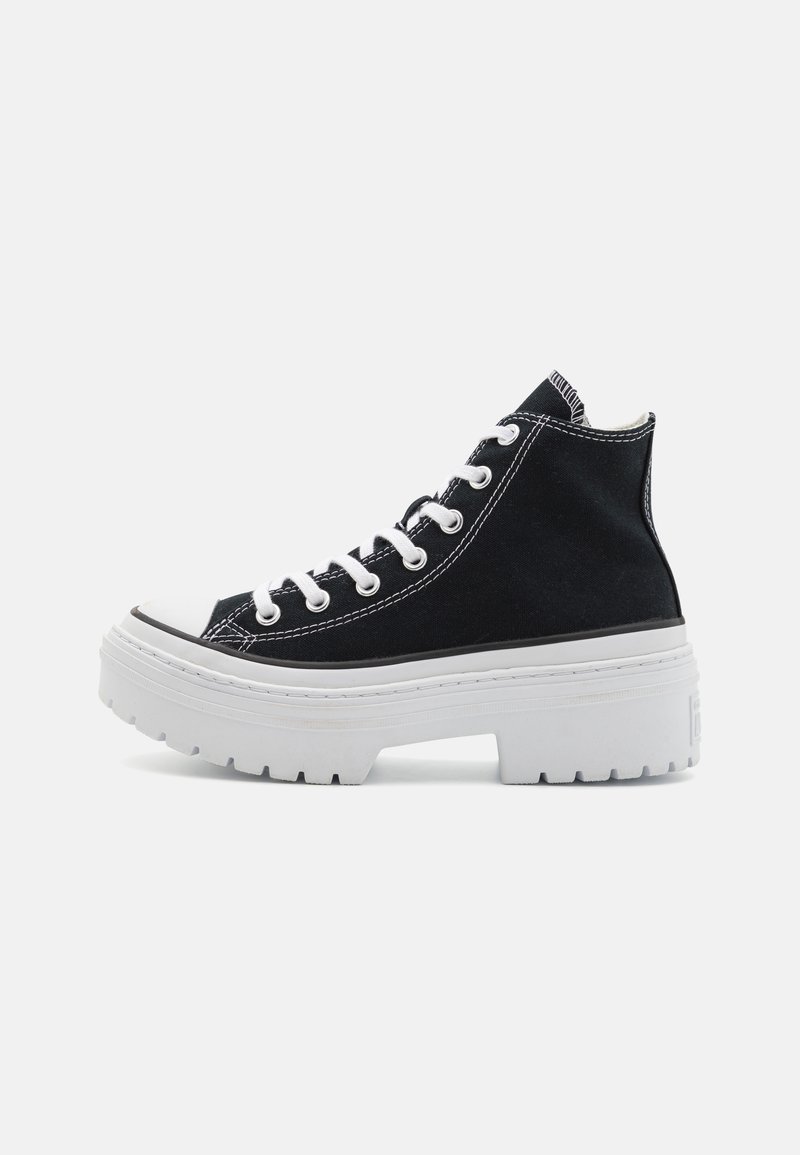 Black high-top canvas sneakers with white rubber sole, featuring contrasting white stitching and classic lace-up design. Chunky platform profile.