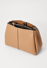 Tan leather handbag with a textured finish, featuring a black zippered interior pocket and contrasting stitching. Sleek, structured design.