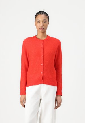Cardigan rosso realizzato in un morbido tessuto testurizzato. Presenta un colletto rotondo e una chiusura a bottoni. Maniche lunghe e polsini a costine per una silhouette aderente.