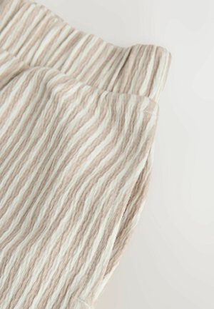 Tissu léger et côtelé aux rayures beige et blanches, doté d'une texture douce et d'une ceinture élastique pour le confort.