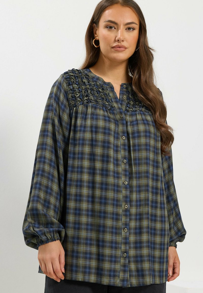 Long-sleeve plaid shirt in green and blue tones, featuring a textured yoke, button-down front, and gathered sleeves.