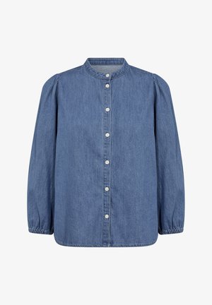 Denim srajca v svetlo modri barvi z visokim ovratnikom, sprednjim zapiranjem na gumb, dolgimi pufastimi rokavi in elastičnimi manšetami. Gladka tekstura.