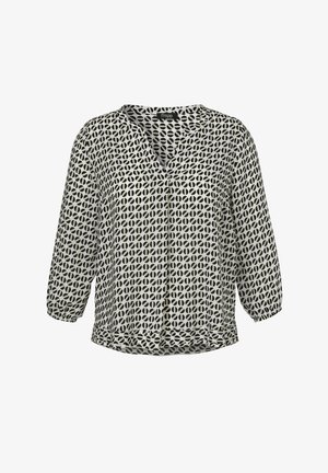 Blouse à manches longues à motif géométrique noir et blanc, col en V, poignets élastiques et coupe ample.