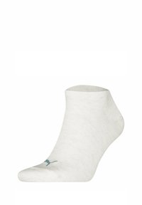 Vita bomullsocka som går till ankeln med ribbad textur, rund tå och en liten blå logotyp på sidan. Lätt och ventilerande design.