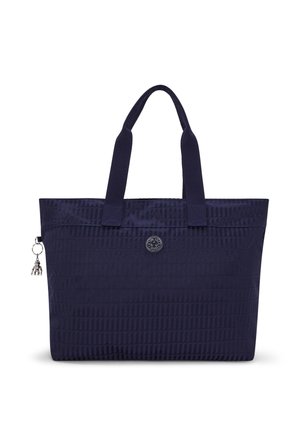 Navy blue tote bag made of textured nylon, featuring two fabric handles, a decorative charm, and a logo accent on the front.