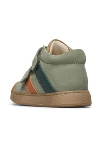 Sneaker verde in suede con strisce marroni e teal, design low-top e chiusura in Velcro, dotata di suola in gomma testurizzata.