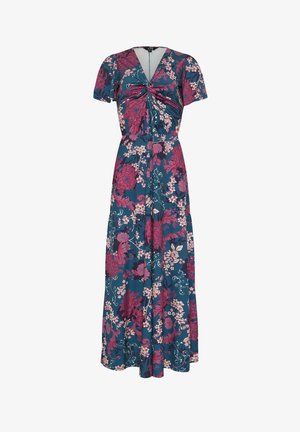 Sinivihreä maksimekko, jossa on lyhyet hihat ja V-pääntiessä solmukuvio. Mekossa on suuret vaaleanpunaiset ja valkoiset kukkakuviot.