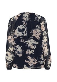 Blusa floreale con sfondo blu navy, caratterizzata da motivi di fiori rosa chiaro e bianchi. Tessuto trasparente con maniche lunghe e svasate e scollatura arrotondata.