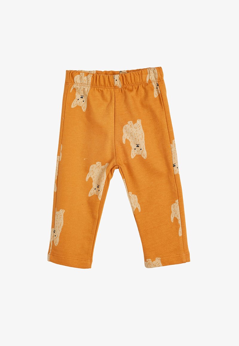 Leggings en coton orange avec une texture douce, présentant un imprimé ours beige avec des détails noirs sur l'ensemble. Taille élastique pour plus de confort.