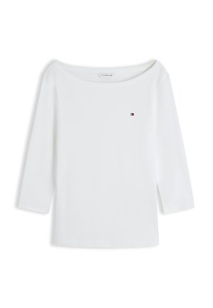White long-sleeve boat neck shirt with small Tommy Hilfiger logo on left chest, displayed on a white background.