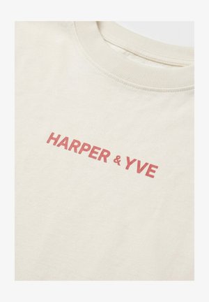 Cream-colored crew neck shirt with red "HARPER & YVE" text printed across the chest.