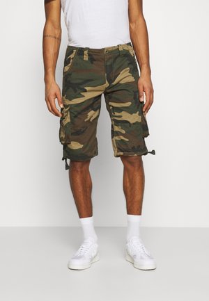 Pantaloni cargo mimetici in verde e marrone, con molteplici tasche e dettagli regolabili con legatura all'orlo. Realizzati in tessuto resistente.