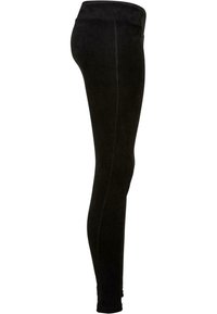 Leggings noirs en tissu côtelé avec une taille élastique lisse. Design ajusté qui descend jusqu'aux chevilles, avec un léger éclat.