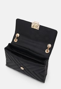 Czarny pikowany skórzany portfel z złotym zapięciem i akcentami łańcucha, z teksturowanym wnętrzem i dwoma przegródkami do organizacji.