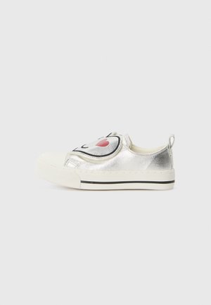 Silver metallic slip-on shoes with a rounded toe, featuring a large black and pink smiley face design on the front and contrasting white sole.