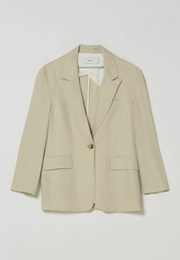 Beżowa lniana marynarka z klapami z nacięciem, pojedynczym zapięciem na guzik oraz dwoma przednimi kieszeniami. Posiada długie rękawy i gładką podszewkę.