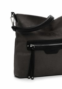 Gray handbag with black leather accents. Features a zippered pocket, textured surface, adjustable strap, and decorative tassel detail.