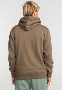 Brown hooded sweatshirt with a soft texture, ribbed cuffs, and hem, featuring a slightly loose fit, displayed from the back.