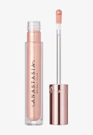 Shimmering peach lip gloss in a clear tube with metallic rose gold cap; flat applicator wand included for even application.