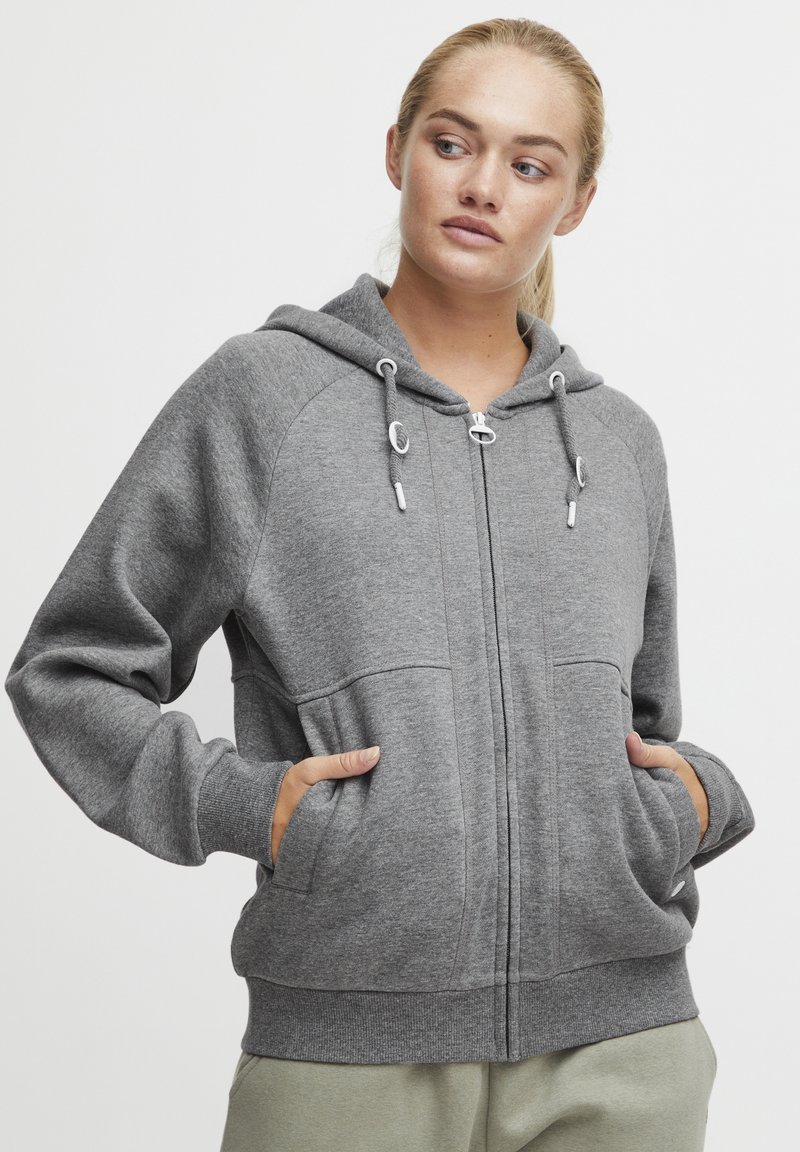 Gray zip-up hoodie with adjustable drawstrings, large front pockets, and ribbed cuffs. Soft fabric with a smooth texture.